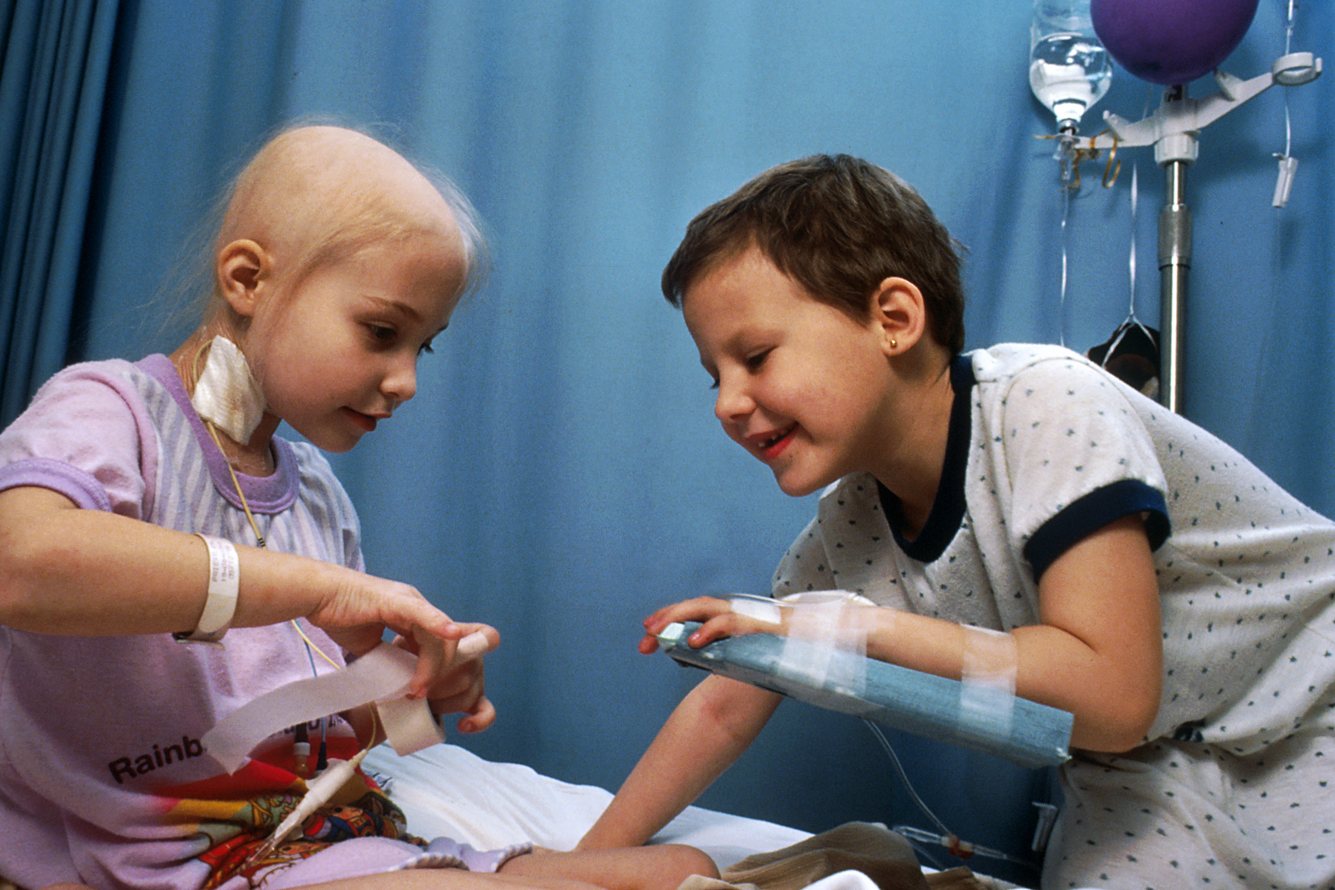 Two acute lymphocytic leukemia patients who are receiving chemotherapy; they are demonstrating some of the procedures used with chemotherapy